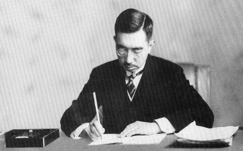 black and white photo of Japan's Emperor Hirohito signing document