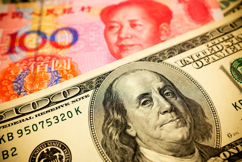 photograph of 100 yuan and $100 bills