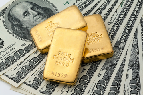 photo of gold bars and $100 bills