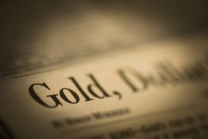 Image of newspaper headline featuring 'Gold, dollar'