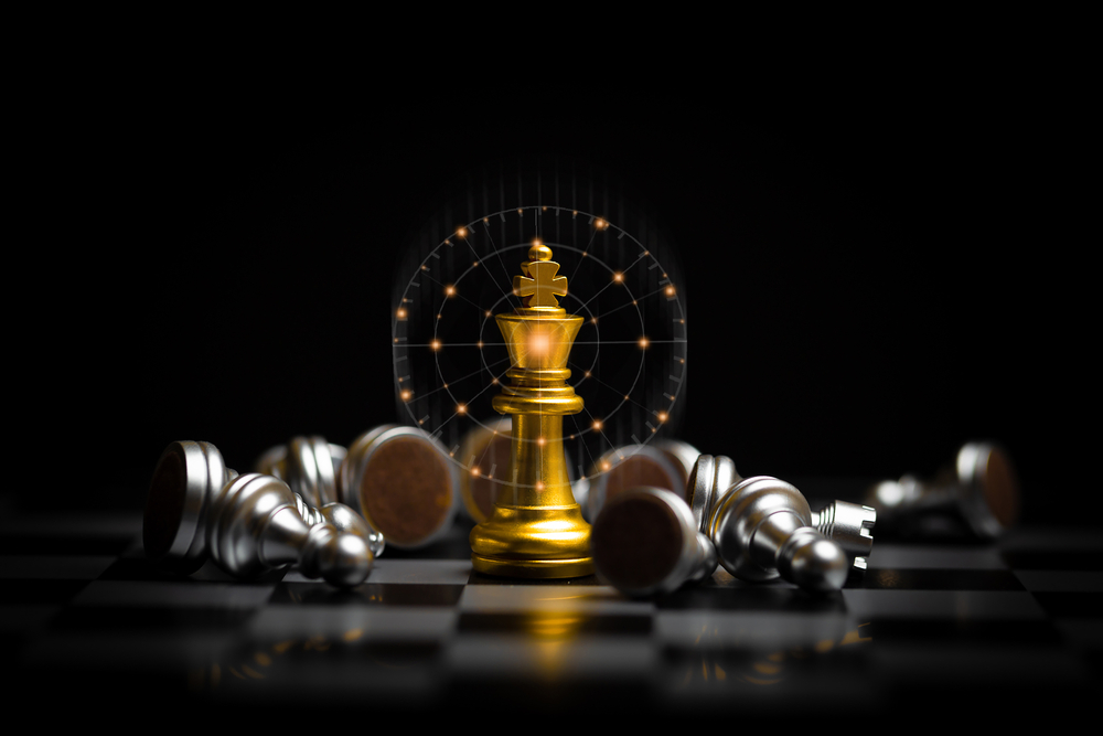 Graphic image of a gold king chess piece surrounded by downed pawns