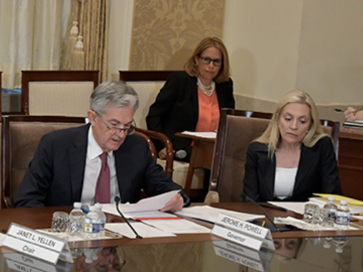 photo showing Jerome Powell and Lael Brainard during Fed Board of Governors meeting
