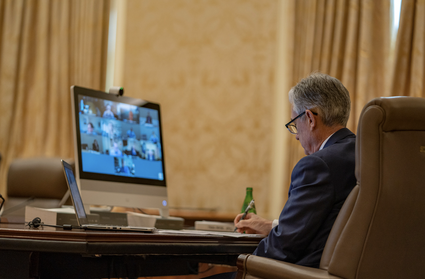 photograph of Jerome Powell in virtual FOMC meeting sitting at computer screen