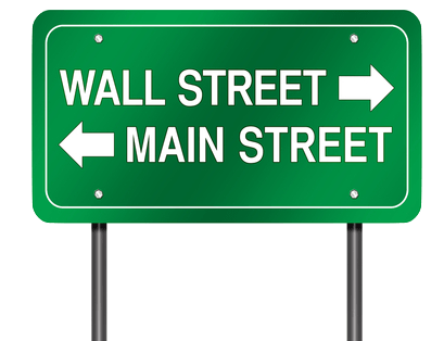 road sign pointing in different directions for Wall Street and Main Street